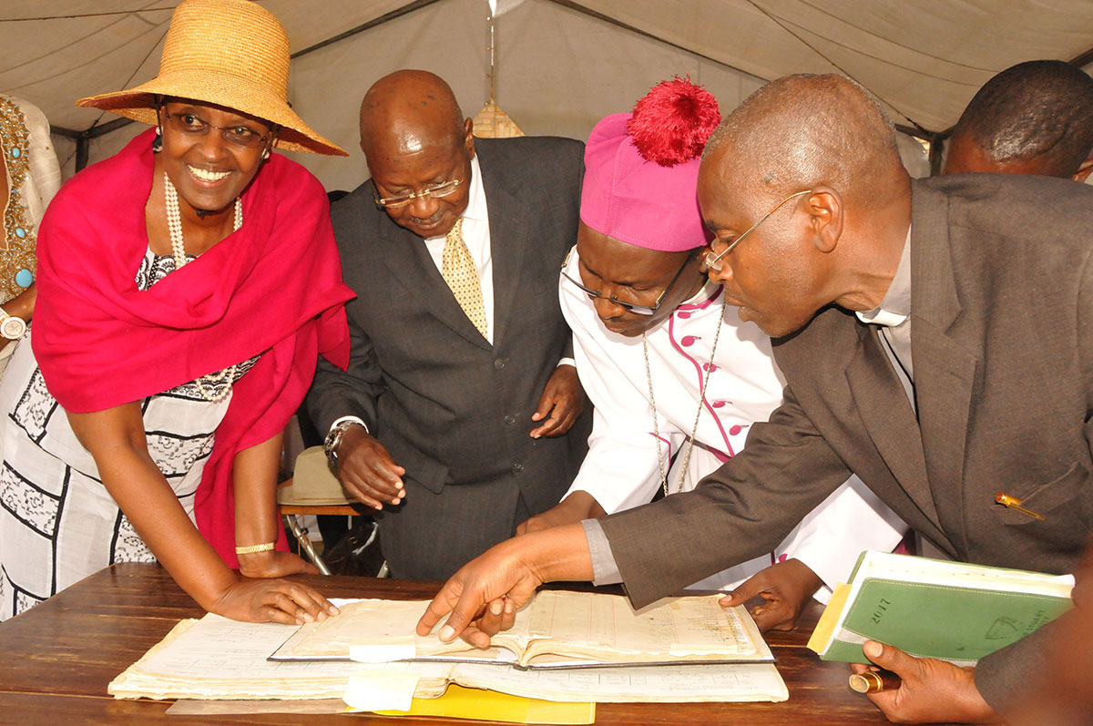 70th-Baptism-anniversary---President-Museveni-being-shown-his-name-in-the-St-Luke-Kinoni-COU-book-of-records.-August-8,-2017.jpg