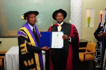 Prof. Rwekaza presents the certificate to Museveni 